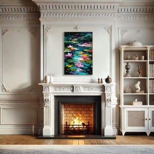 May include: An abstract painting of a water lily pond with vibrant colors. The artwork features pink, yellow, and white lily pads floating on a teal and dark green water surface. The painting is framed and hangs above a fireplace.