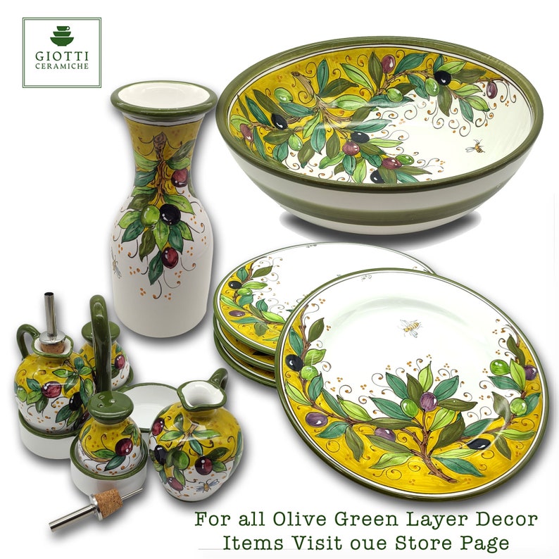 May include: Olive green and yellow ceramic serving bowl, plates, and oil and vinegar cruets with olive branch and bee designs. For all Olive Green Layer Decor Items Visit our Store Page.