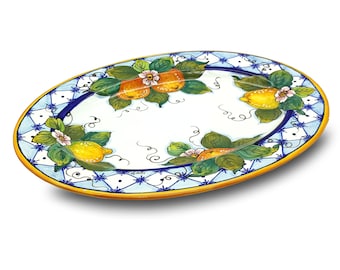 May include: Oval ceramic serving platter with a blue and white checkered border and a lemon and orange fruit design. The platter has a yellow rim.