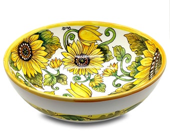 May include: A white ceramic bowl with a yellow rim and a sunflower design. The bowl is decorated with yellow sunflowers, green leaves, and yellow and green vines.