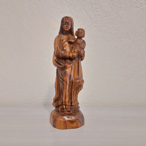 Madonna and child wood carving statue. Mother and child carved wood statue.
