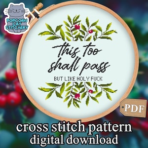 May include: A cross-stitch pattern in a wooden hoop features the text "This too shall pass BUT LIKE HOLY FUCK" surrounded by green leaves and red berries. The design is a digital download.