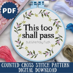 May include: A counted cross stitch pattern featuring a floral wreath with the text "This too shall pass but like holy fuck". The pattern is available as a digital download.