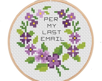 May include: A white embroidery hoop with a cross-stitch design of purple flowers and green leaves. The text "PER MY LAST EMAIL" is stitched in black thread.