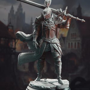 May include: A detailed figurine of a knight in full armor, holding a large sword over their shoulder. The knight's helmet, chest plate, and leg armor are intricately designed. The figure stands on a stone base, with a blurred background of a medieval town.