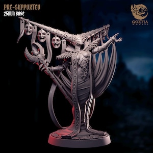 May include: A detailed 3D-printed miniature of a female figure, adorned with intricate armour and flowing robes. She holds a staff and is crowned with a headdress featuring hanging masks. The base is 25mm. The text "PRE-SUPPORTED" and "25mm BASE" is visible.