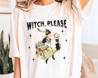 Puede incluir: Camiseta color crema con el texto "WITCH, PLEASE" sobre una ilustración vintage. El gráfico representa a una mujer con un disfraz de bruja en una luna creciente, ofreciendo una corona a un gato negro. Estrellas negras adornan la imagen.