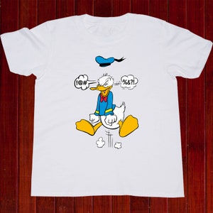 May include: White t-shirt with a cartoon image of Donald Duck with a blue sailor hat. Donald Duck is angry and has speech bubbles above his head that say "!@#" and "#%&?!".