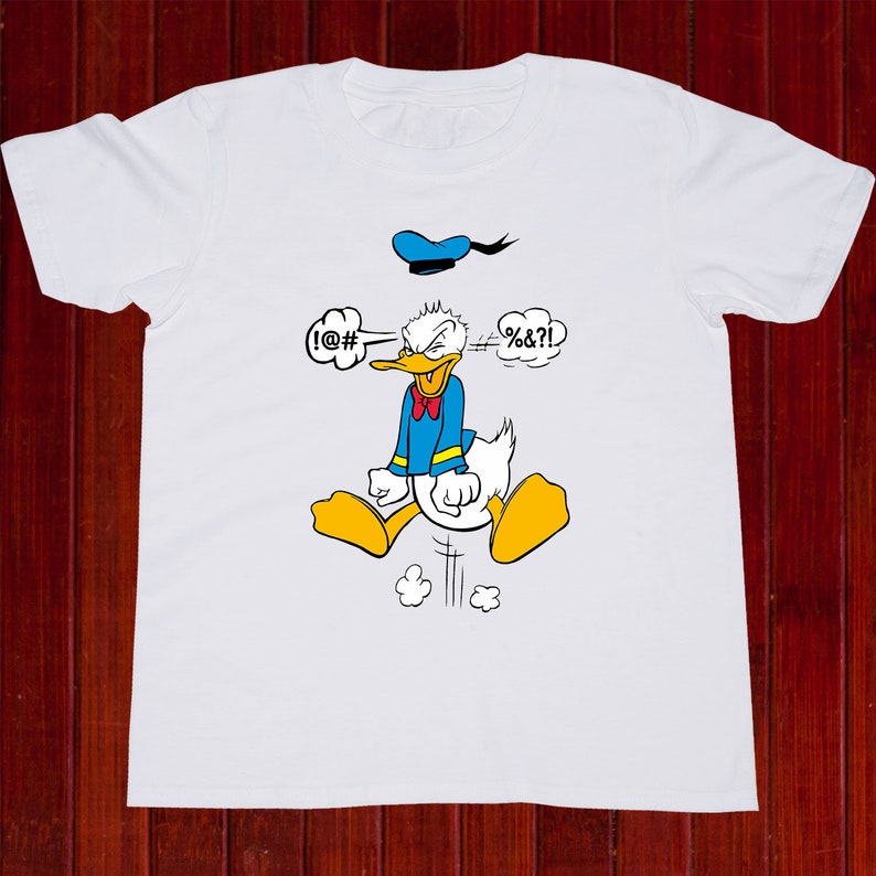 May include: White t-shirt with a cartoon image of Donald Duck with a blue sailor hat. Donald Duck is angry and has speech bubbles above his head that say "!@#" and "#%&?!".