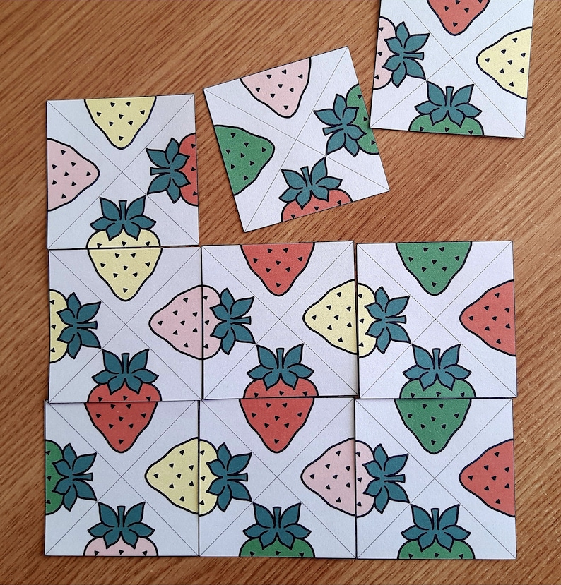 May include: Nine square tiles with a white background and a repeating pattern of green, pink, and yellow strawberries. Each tile has a white grid pattern with diagonal lines.