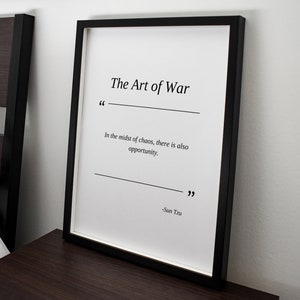 May include: Black and white framed print with the text "The Art of War" and a quote from Sun Tzu: "In the midst of chaos, there is also opportunity."