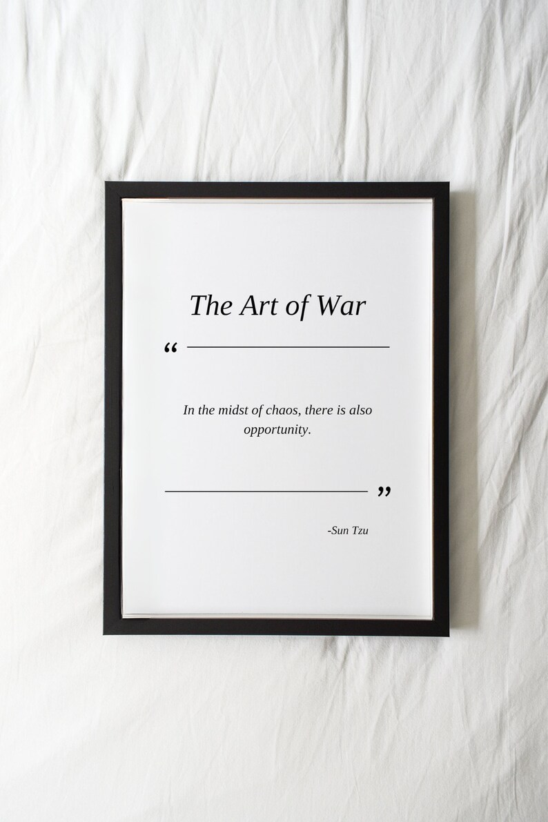 May include: A black framed print with a white background and the text "The Art of War" in black. The quote "In the midst of chaos, there is also opportunity." is printed below the title, followed by the attribution "Sun Tzu".