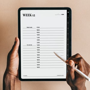 May include: A digital tablet with a weekly planner on the screen. The planner is for week 12 and includes a section for main goals and a to-do list. The tablet is being held by a person's hands and a stylus is being used to write on the screen. The text on the screen reads "WEEK 12" and "MON".