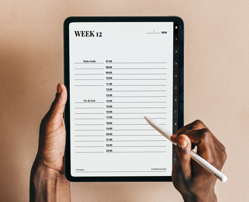 May include: A digital tablet with a weekly planner on the screen. The planner is for week 12 and includes a section for main goals and a to-do list. The tablet is being held by a person's hands and a stylus is being used to write on the screen. The text on the screen reads "WEEK 12" and "MON".