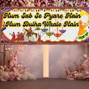 May include: A decorative sign with the text "Hum Sab Se Pyare Hain Hum Dulha Waale Hain" in yellow and black. The sign features illustrations of people, horses, and umbrellas, with a colorful border. The background is a floral arrangement.