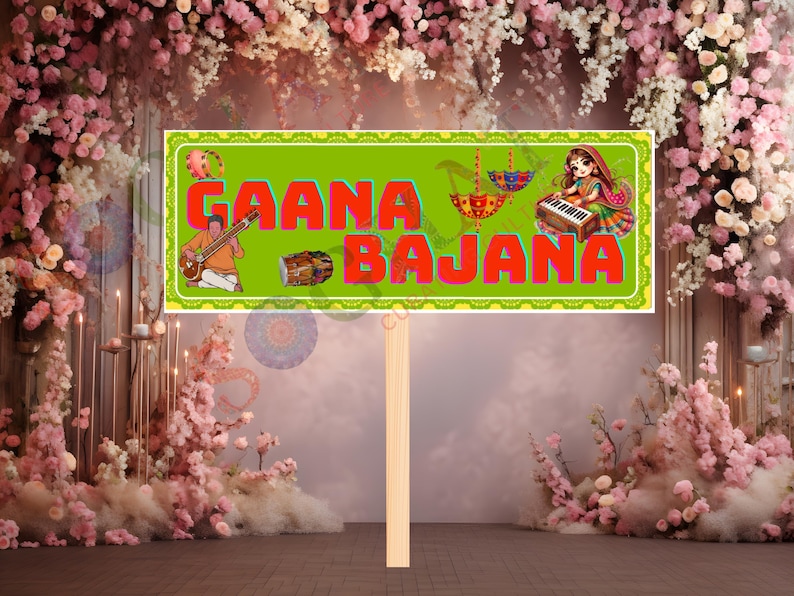 May include: A rectangular sign with the words "GAANA BAJANA" in red letters on a green background. The sign features illustrations of musical instruments and figures. The sign is held by a wooden stick, set against a floral backdrop.