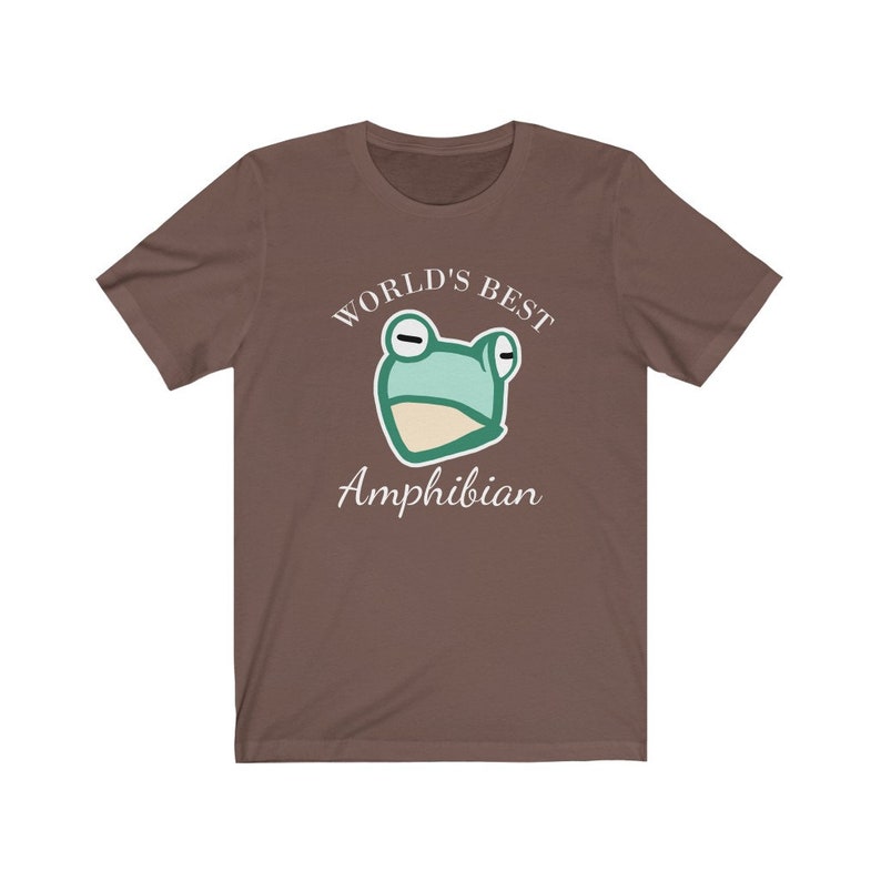 May include: A brown t-shirt with a white graphic of a cartoon frog and the text "WORLD'S BEST AMPHIBIAN".