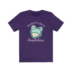 May include: Purple t-shirt with a green frog illustration and the text "World's Best Amphibian".