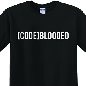 May include: Black t-shirt with the white text "[CODE]BLOODED" across the chest. The shirt is a crew neck style and appears to be made of cotton. The Gildan logo is visible on the collar.