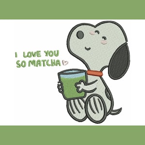 May include: An embroidered design featuring a cartoon dog holding a green matcha drink. The dog is light gray with black ears and a red collar. Text above the dog reads "I LOVE YOU SO MATCHA" in green.