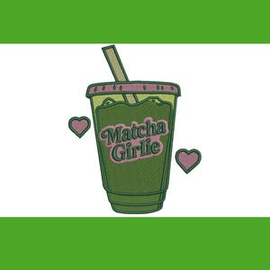 May include: An embroidered design featuring a green matcha drink in a clear cup with a pink lid and straw. The text "Matcha Girlie" is in pink script. Two pink hearts flank the cup. The design is on a white background.