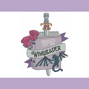 May include: Embroidered design featuring a sword piercing a box with the text "SHOULD I GET THE WINGIEADER". The design includes two pink roses, a banner, and a small dragon with wings. The color palette includes shades of purple, pink, and gray.
