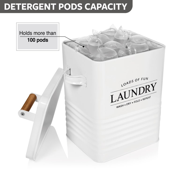 May include: White metal laundry pod storage container with a lid and a wooden handle. The container has a black and white label that says "Loads of Fun Laundry Wash Dry Fold Repeat". The container is filled with laundry pods.