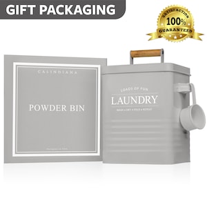 May include: Gray metal laundry powder bin with a wooden handle and a scoop. The bin has the words "Loads of Fun" and "Laundry" printed on it. The bin is labeled "Calindiana Powder Bin".
