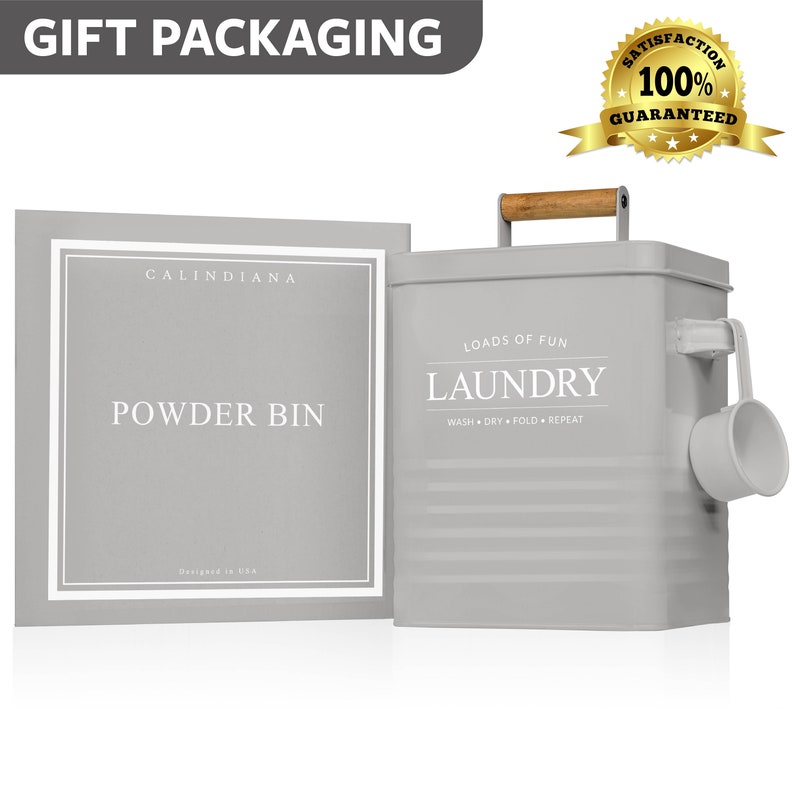 May include: Gray metal laundry powder bin with a wooden handle and a scoop. The bin has the words "Loads of Fun" and "Laundry" printed on it. The bin is labeled "Calindiana Powder Bin".