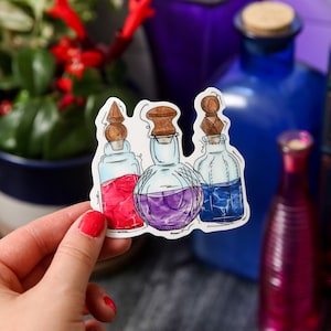 May include: A sticker featuring three glass bottles with cork stoppers and colorful liquids inside. The bottles are drawn in a cartoon style with a white background.