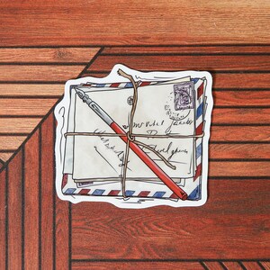 May include: A stack of vintage envelopes tied with twine and a red pen, with handwritten text on the envelopes. The envelopes have a blue and red striped pattern.