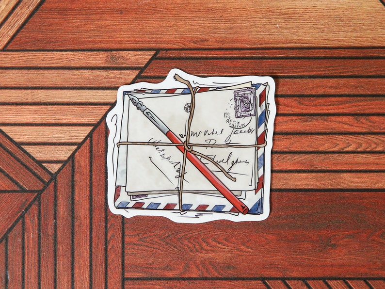 May include: A stack of vintage envelopes tied with twine and a red pen, with handwritten text on the envelopes. The envelopes have a blue and red striped pattern.