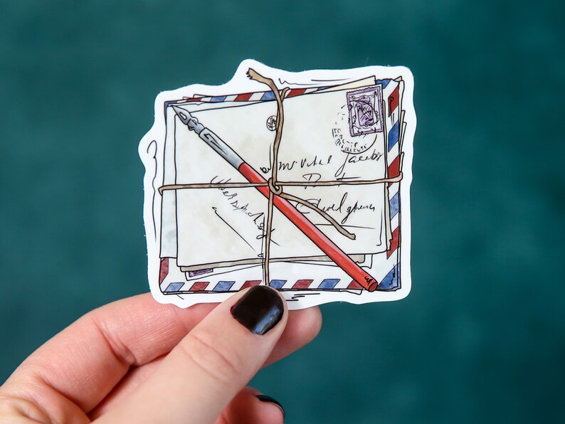 May include: A sticker of a stack of envelopes tied together with twine and a red and black pen. The envelopes have a blue and red striped pattern and are addressed with handwritten text.