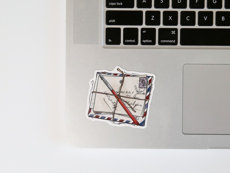 May include: A sticker of a stack of envelopes tied with twine and a red pen. The envelopes are decorated with a blue and red striped pattern and have handwritten text.