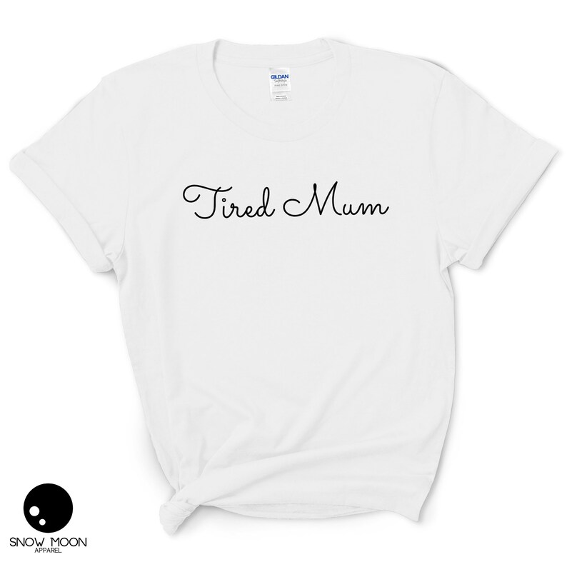 May include: White t-shirt with the text "Tired Mum" in black cursive writing.