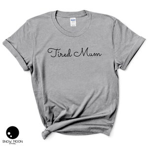 May include: A gray t-shirt with the text "Tired Mum" in black cursive lettering.