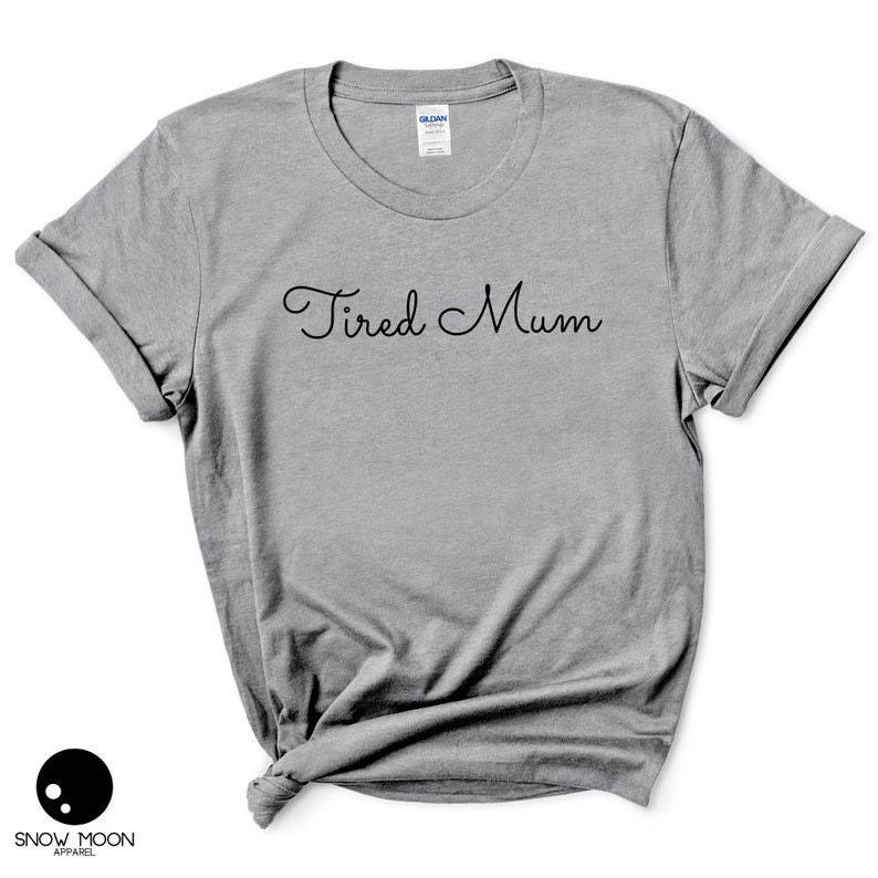 May include: A gray t-shirt with the text "Tired Mum" in black cursive lettering.