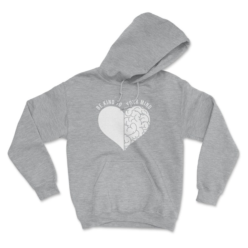 May include: A gray hooded sweatshirt with a white heart design. The heart is split in half, with one side being a brain and the other side being a blank space. The text "BE KIND TO YOUR MIND" is printed around the heart.