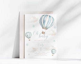 May include: A white baby shower invitation card featuring watercolour illustrations of three blue and white striped hot air balloons, soft beige clouds, and small blue stars. The text reads Oh baby, BABY ALDER IS ON THE WAY, Emily, and event details.