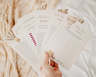 May include: Four printable baby shower game cards with a hot air balloon theme. The games are Guess Who, The Price is Right, Who Knows Dad, and Baby Name Race.