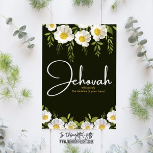 May include: A black card with white flowers and green leaves at the top and bottom. The card has white text that says "Jehovah will satisfy the desires of your heart".