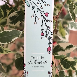May include: A light blue bookmark with a floral design and the text "Trust in Jehovah - Isaiah 30:15".