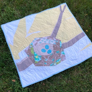 Modern Quilt Improv Bird Nest design. One of a kind. Machine pieced quilted with appliqué eggs and hand sewn binding with mitered corners.