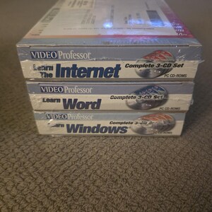 May include: A stack of three shrink-wrapped Video Professor software boxes for PC. The titles include Learn The Internet, Learn Word, and Learn Windows. Each box is a complete 3-CD set featuring blue and white branding with visible disc graphics.