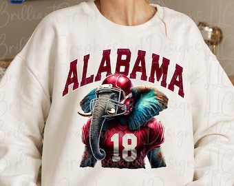 May include: White sweatshirt with a red and blue graphic of an elephant wearing a football helmet and jersey with the word "ALABAMA" and the number "18" on it.