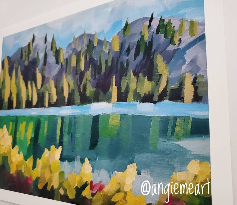 May include: A painting depicting a lake with a forest in the background. The lake is a vibrant blue-green colour and the forest is a dark green with touches of yellow. The painting is executed in a loose, impressionistic style.