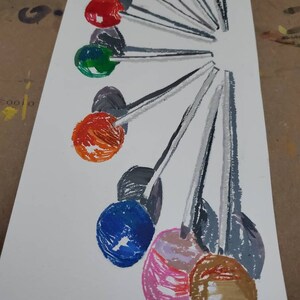 May include: A painting of a fan of colorful lollipops with gray sticks on a white background.