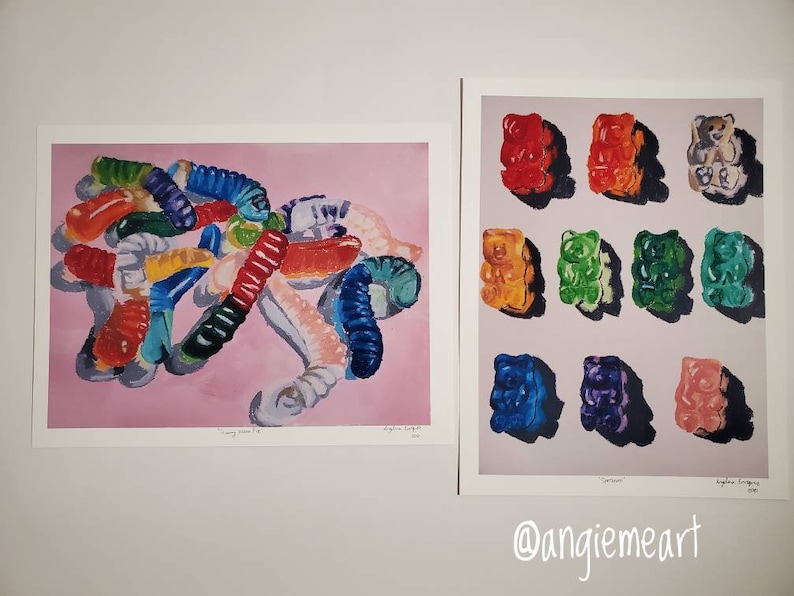 May include: Two watercolor paintings of gummy candies. The first painting shows a pile of colorful gummy worms on a pink background. The second painting shows nine gummy bears in different colors arranged in a grid on a light gray background.