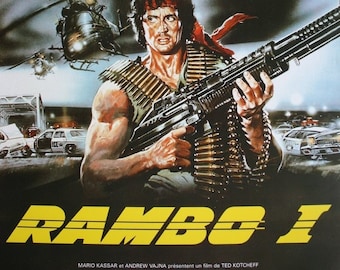 May include: A movie poster for the film "Rambo: First Blood" starring Sylvester Stallone. The poster features a close-up of Stallone holding a machine gun, with helicopters and police cars in the background. The title "Rambo I" is in large yellow letters.