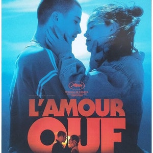 May include: A movie poster for the French film "L'Amour ouf" directed by Gilles Lellouche. The poster features a couple embracing in a blue and red color scheme. The title of the film is in large, bold letters. The poster also includes the names of the actors and the release date: "AU CINÉMA LE 16 OCTOBRE".